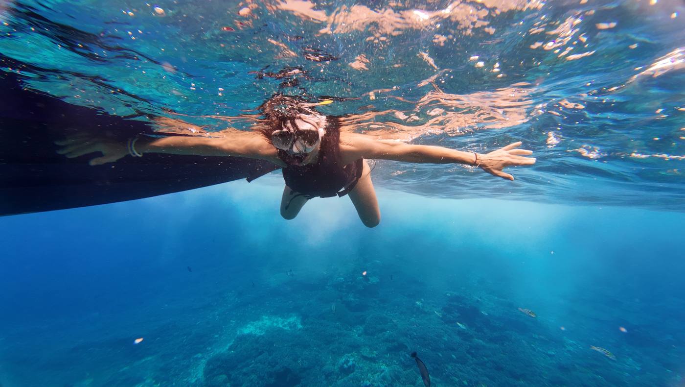 Guest snorkeling beside the boat