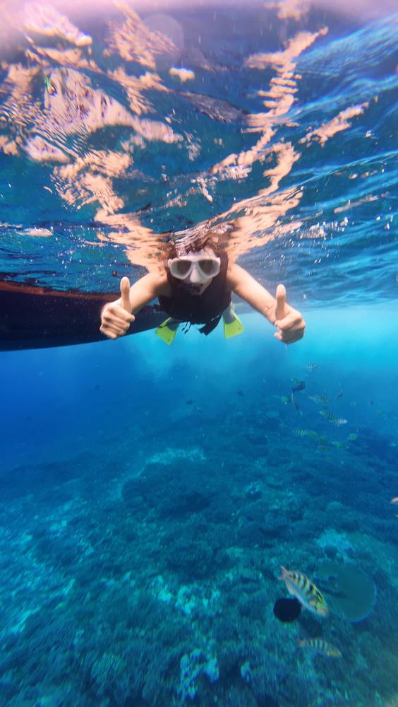 Guest giving a thumbs up while snorkeling